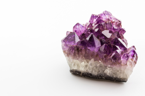 Crystal Stone, purple rough amethyst crystals on white background.