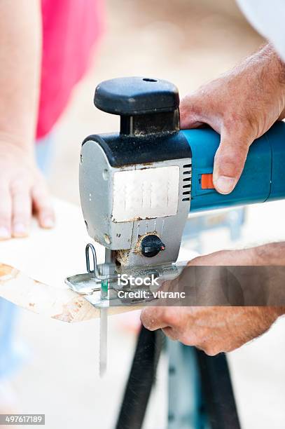 Man With Jigsaw Cutting A Plank Stock Photo - Download Image Now - Accuracy, Adult, Adults Only