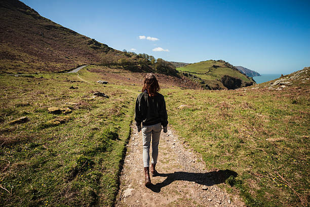 istock Woman walking along path in the mountains 497619633