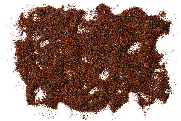 Close-up of ground coffee beans texture isolated on white background.