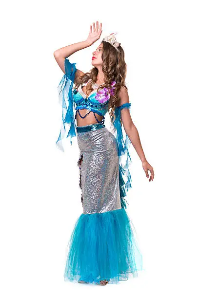 Carnival dancer girl dressed as a mermaid posing, isolated on white background in full length.