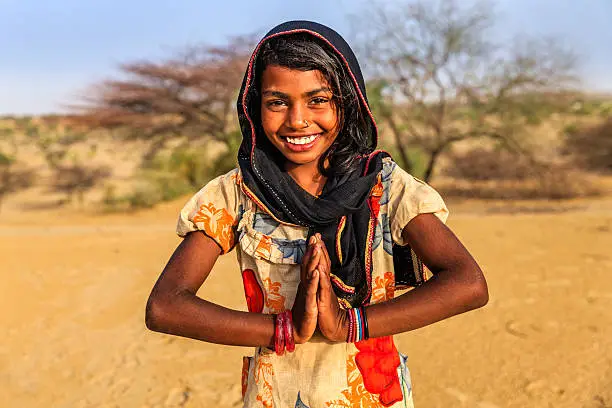 Namaste! - Portrait of happy Indian girl in desert village, India