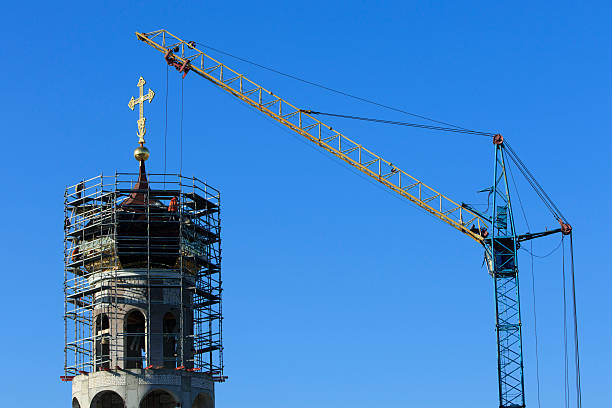 building of the Christian church with crane, scaffolding and builders