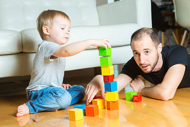 istock father play block with his son at home 497629550