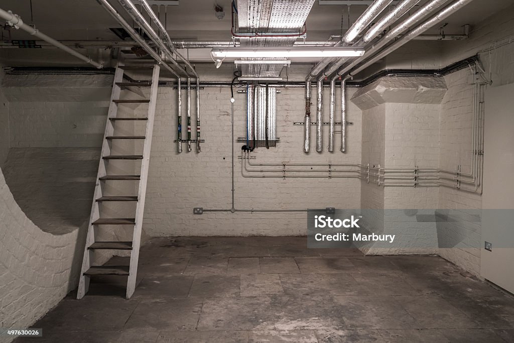 Basement Pipes Modern plumbing in the basement of an old building. Basement Stock Photo