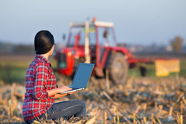 istock Woman with laptop in corn field 497630188