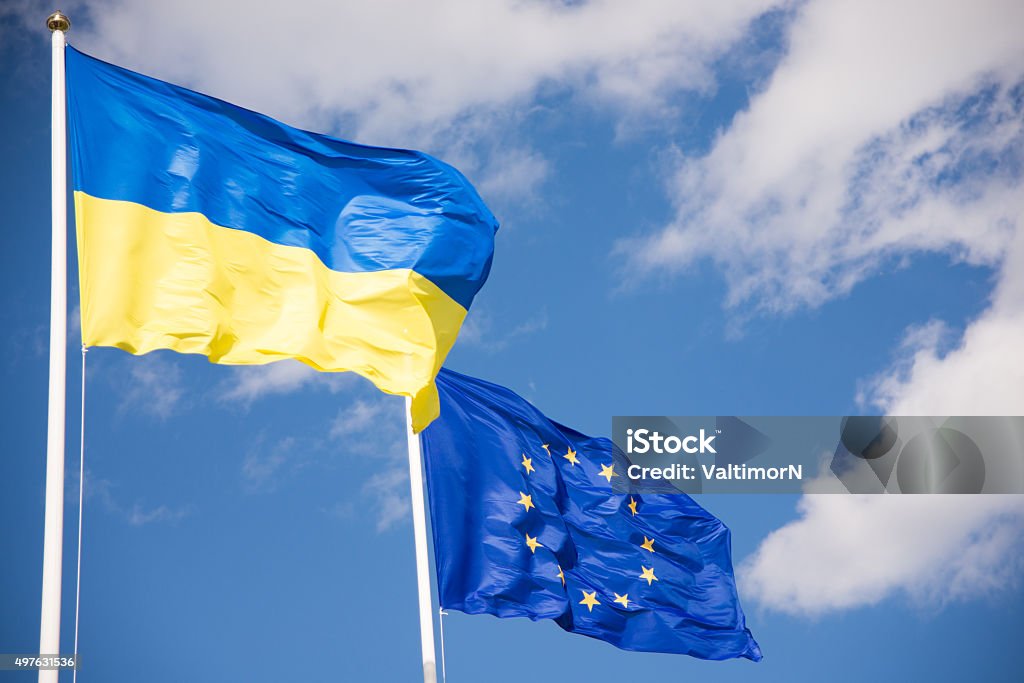Flags of Ukraine and European Union (EU) Flags of Ukraine and European Union (EU) with blue sky background Ukraine Stock Photo