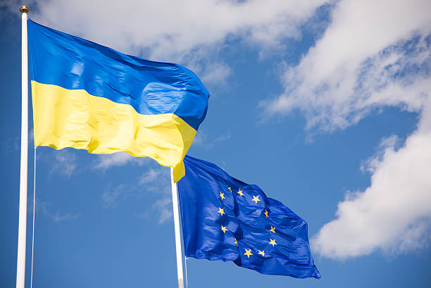 Flags of Ukraine and European Union (EU) Flags of Ukraine and European Union (EU) with blue sky background international border photos stock pictures, royalty-free photos & images
