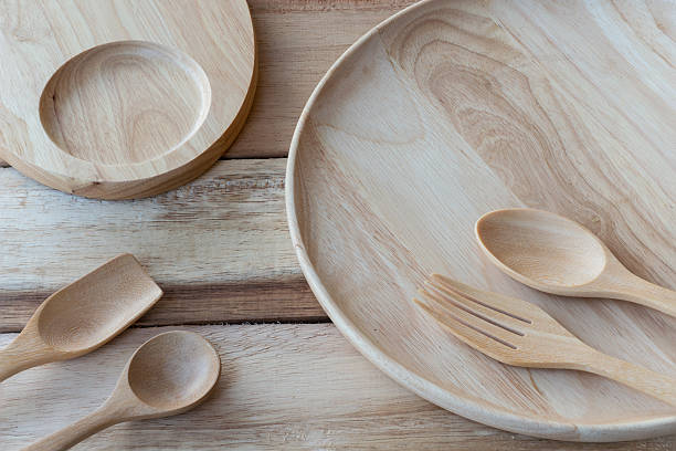 istock wood dish and wood fork on wooden table.with Text Space 497633408