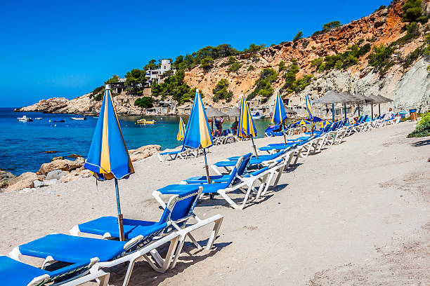 istock Deck chairs over the sand in a idyllic beach. Ibiza. 497634243