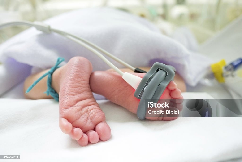 Baby feet and oxygen monitor baby feet and oxygen saturation monitor Baby - Human Age Stock Photo