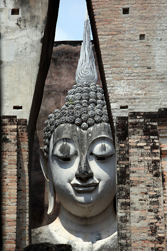 The Buddha figure in the Wat Si Chum temple in the temple complex of Old Sukhothai in the province of Sukhothai in the north of Thailand in South East Asia.