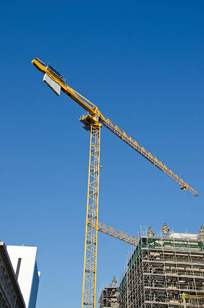 istock yellow building crane and house construction in city 497635473