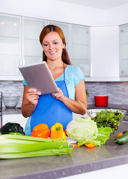 istock Young woman looking for a recipe online 497635832