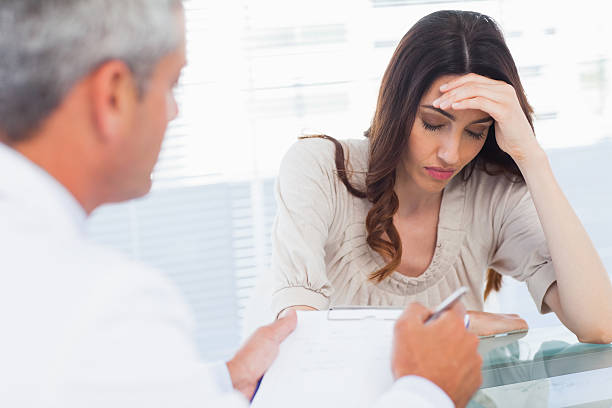 istock Upset woman listening to her docter talking about a illness 497635897