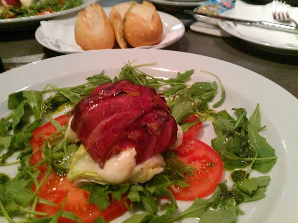 istock Mozzarella rolls wrapped in strips of bacon and salad 497636735