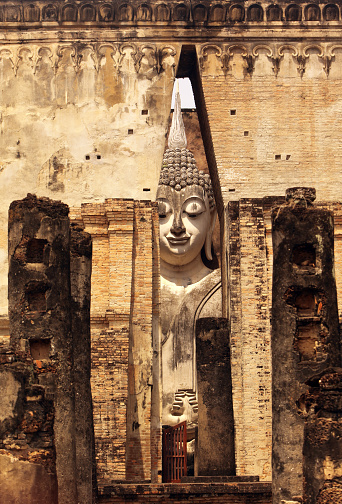 The Buddha figure in the Wat Si Chum temple in the temple complex of Old Sukhothai in the province of Sukhothai in the north of Thailand in South East Asia.