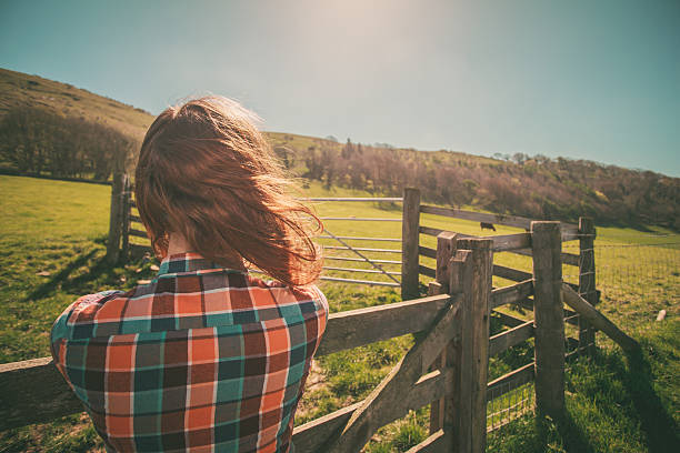 istock Young woman by a fence on a ranch 497637557