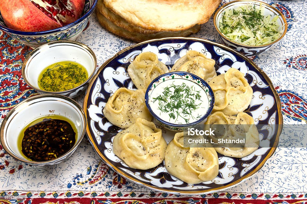 Manti or Mantu are dumplings popular in most Asia cuisines manti - dumplings of minced lamb wrapped in unleavened dough and cooked by steaming 2015 Stock Photo