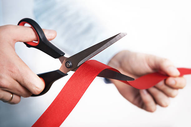 istock Red ribbon cutting for open new project 497639618