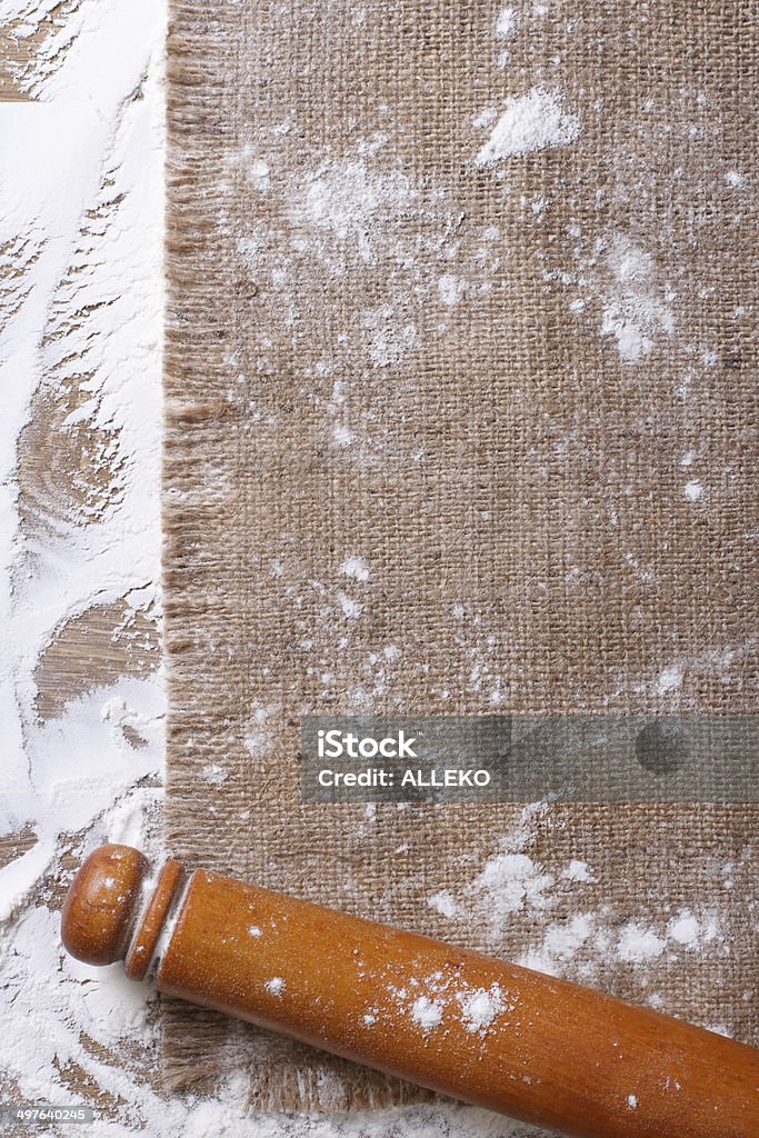 rolling pin on sackcloth and sprinkled flour rolling pin on sackcloth and sprinkled flour on wooden board close up vertical Above Stock Photo