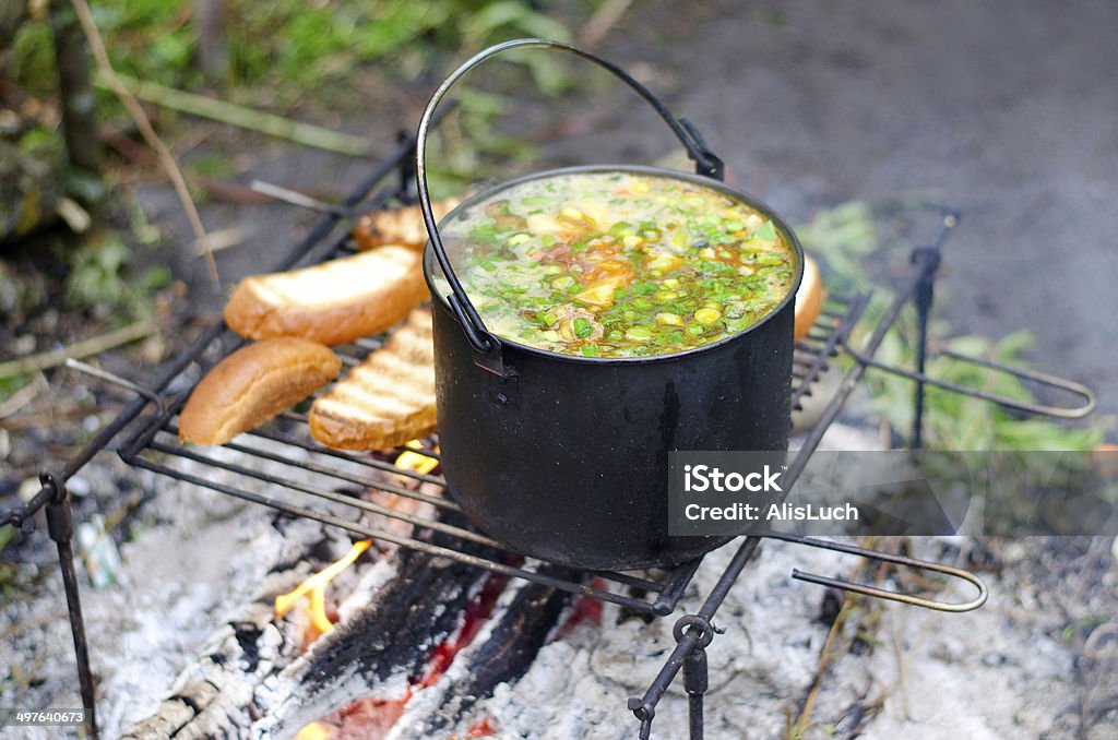 The cooking of soup on the fire The cooking of soup on the fire on the camping Bread Stock Photo