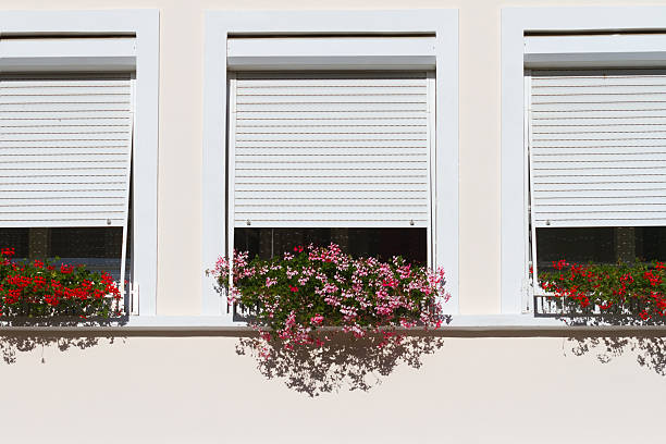 istock Windows with the sun tents and geranium. 497641304