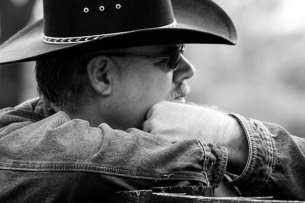istock Black & White Side Profile of Man Wearing Cowboy Hat 497651106