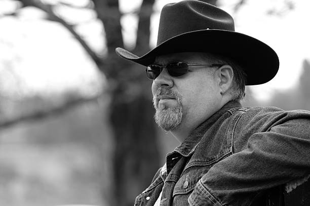 istock Black & White Image of Man Wearing Cowboy Hat 497651148