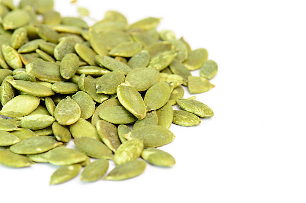 istock pumpkin seeds isolated on white background 497653548