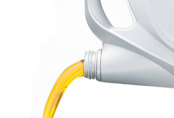 istock Pouring motor oil on white background 497653580