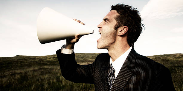 istock Businessman Shouting Megaphone Field Concept 497653724