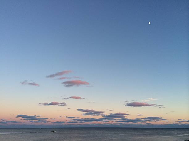 istock Vast Sky at Dusk with Sunset, Moon, Ocean and Boat 497654594