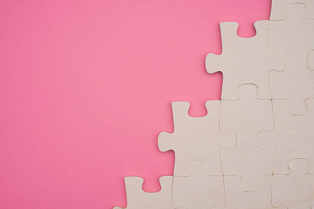 istock jigsaw puzzle on a pink background with copy space 497658382