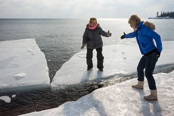romantic couple walking on the frozen lake and snow