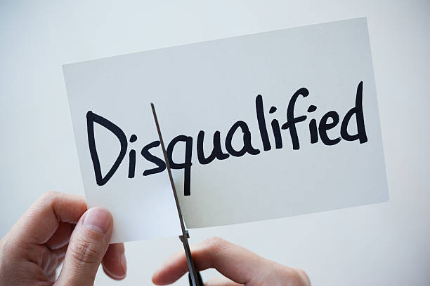 istock Using Scissors Cut the Word on Paper Disqualified Become Qualified 497661392