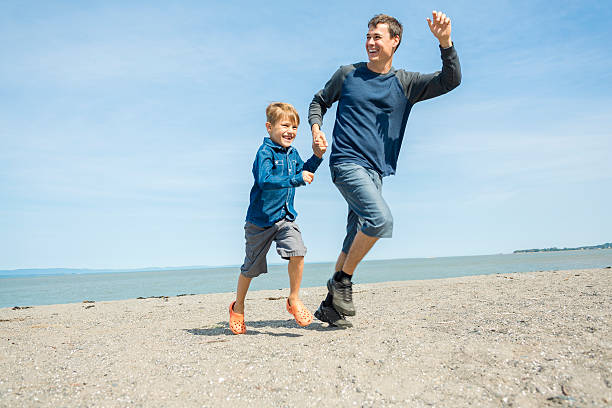 istock father play son side of the beach 497661454