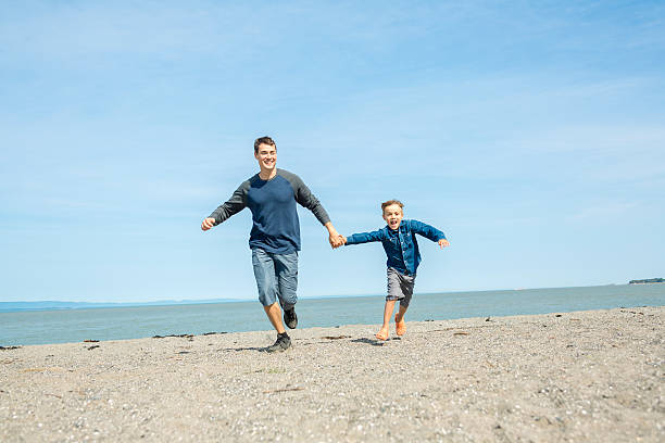 istock father play son side of the beach 497661470