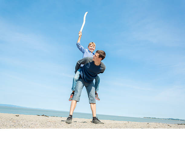 istock father play son side of the beach 497661858