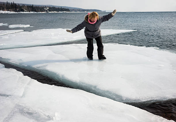 istock Woman balances on an ice floe 497662240