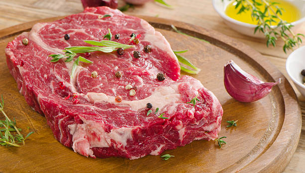 istock Raw Beef Steak on  a wooden  board. 497664822
