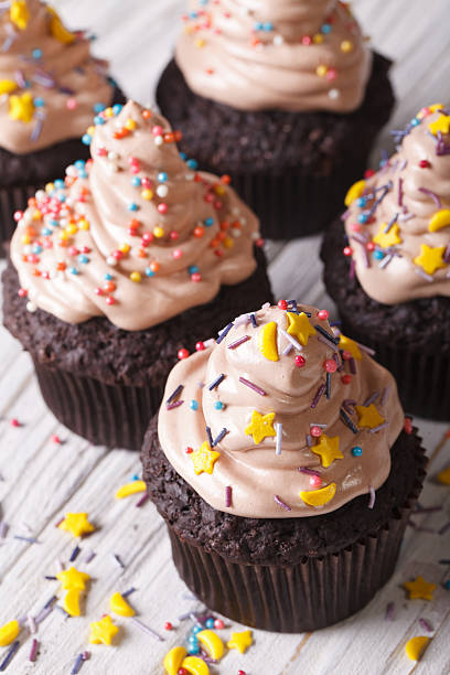 istock Chocolate cupcakes decorated with delicate cream close-up. verti 497665080