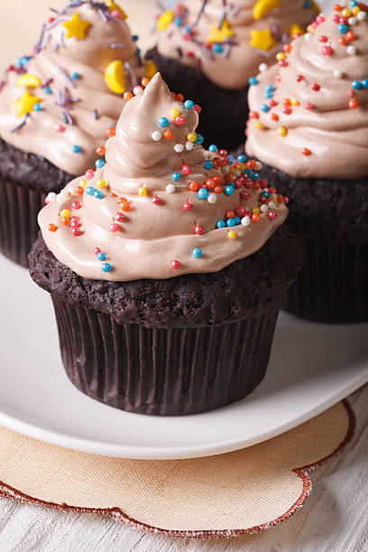 istock Beautiful chocolate cupcakes decorated with candy sprinkles 497665428