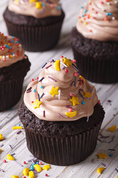 istock Chocolate cupcakes decorated with stars and moon vertical 497665734