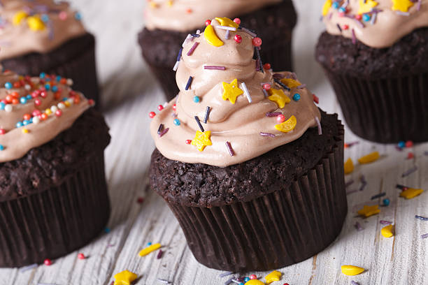 istock Chocolate cupcakes decorated with cream close-up. Horizontal 497666274