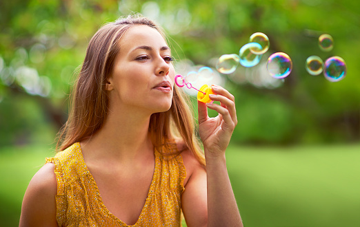 Shot of a carefree young woman blowing bubbles in the parkhttp://195.154.178.81/DATA/i_collage/pi/shoots/805935.jpg