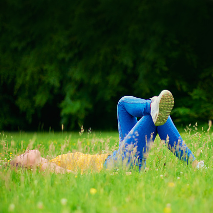 Shot of a young woman lying down in a field of grasshttp://195.154.178.81/DATA/i_collage/pi/shoots/805935.jpg