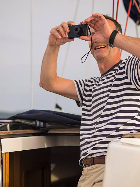 istock Man taking a photo while sailing on Adriatic Sea, Croatia 497680022