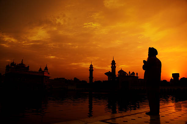 Sikh prayer at golden temple, Amritsar Silhouette of Sikh prayer at golden temple, Amritsar, India religious celebration stock pictures, royalty-free photos & images