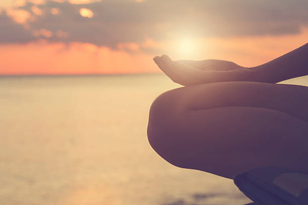 istock Young woman practicing yoga on the beach. 497680754